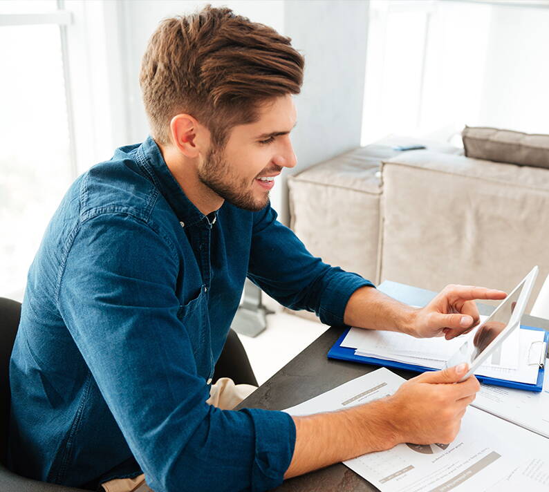 Easily calculate the value of household contents A person reviews documents and researches on a tablet to accurately determine the current value of their household contents.